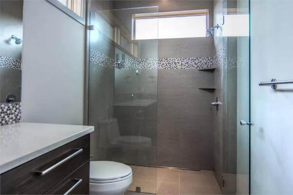 Modern Shower with Sleek Glass EnclosureโCheck Out the Pebble Mosaic!