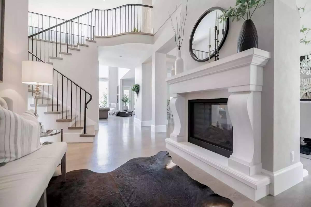 Experience the Elegance of a Curved Staircase and Bold Fireplace