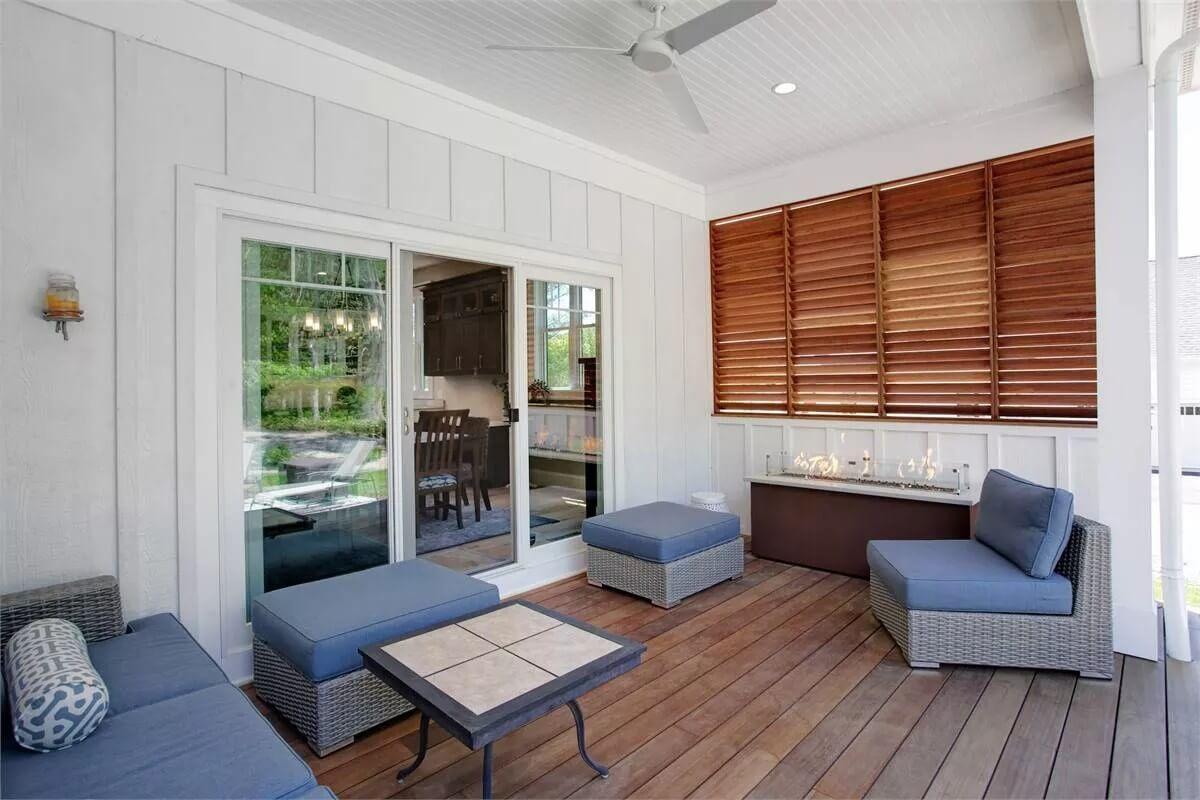 Relaxing Craftsman Porch with a Cozy Seating Area and Fireplace