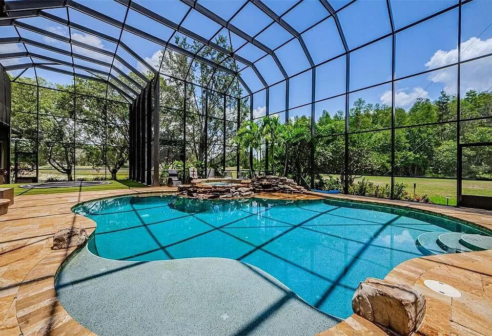 Wow, an Enclosed Pool Area with Lush Views and Waterfall Feature