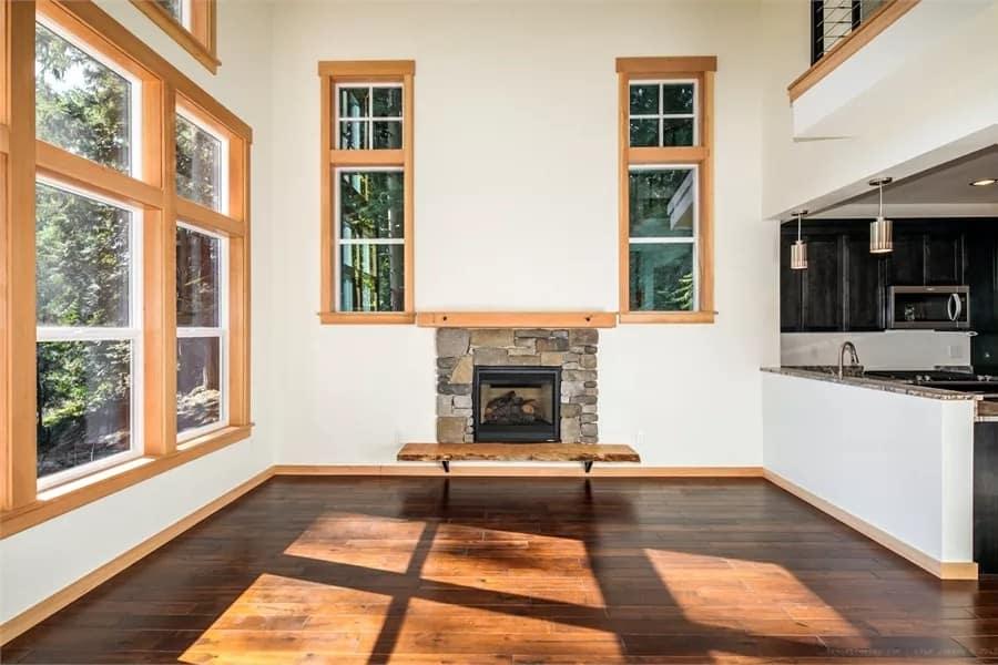 Stone Fireplace and Expansive Windows Combine for a Dramatic Effect