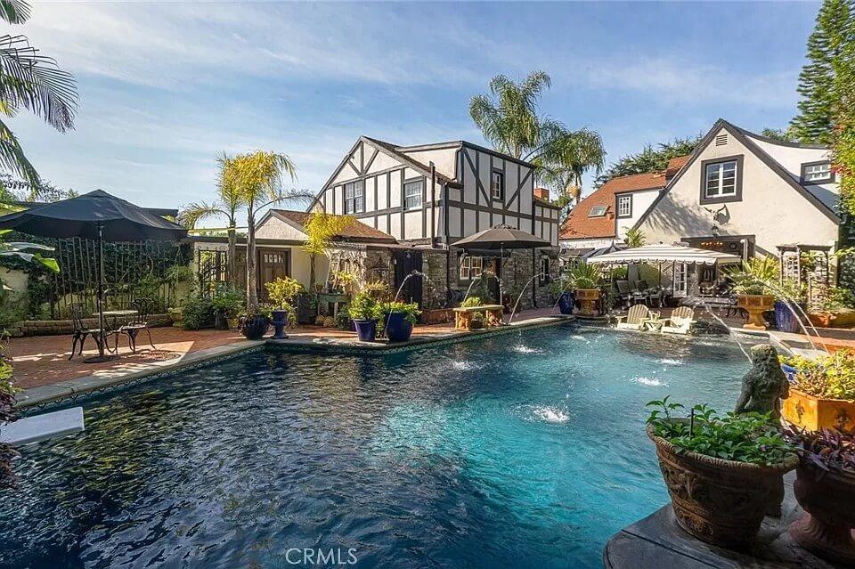Lush Poolside Paradise with Tudor Charm and Vibrant Foliage