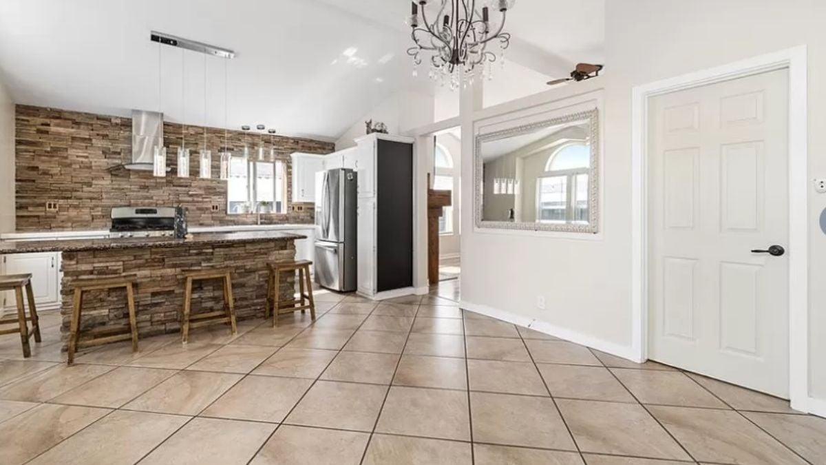 Notice the Stunning Stone Accent Wall in This Open Kitchen