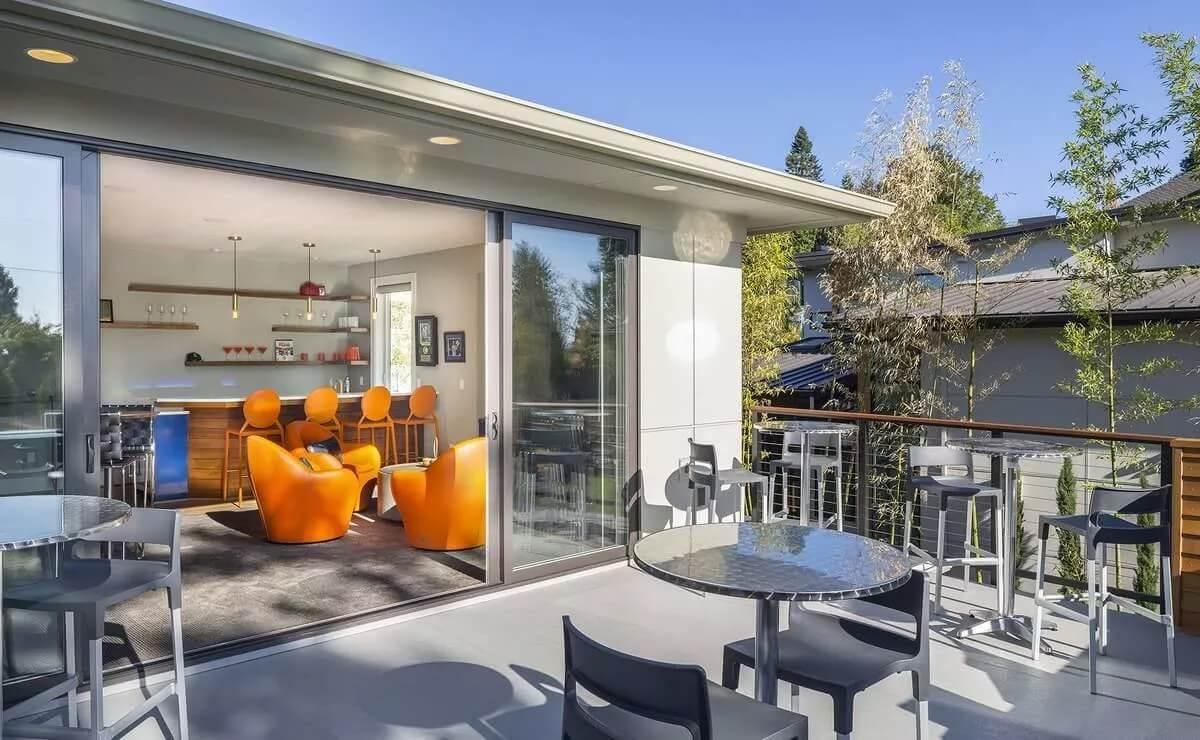 Bold Orange Accents in a Sunlit Lounge Area With Outdoor Access
