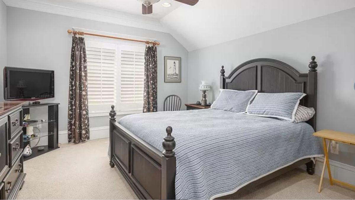 Classic Guest Bedroom With a Stately Wooden Bed Frame