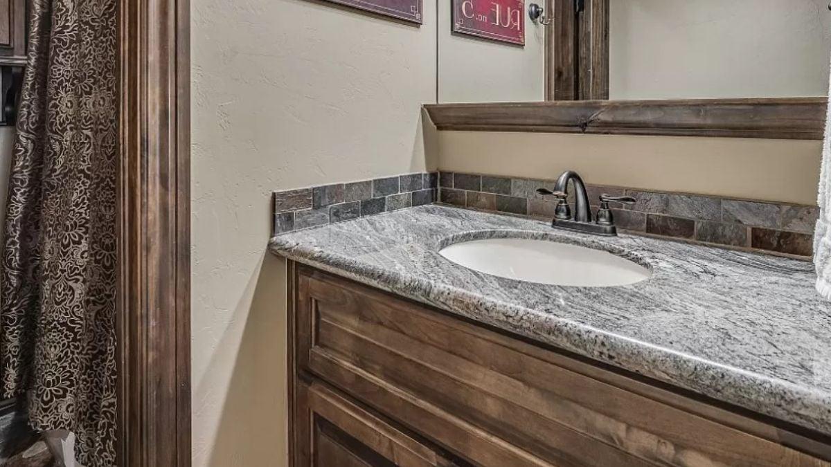 Check Out the Granite Vanity Top and Rustic Woodwork in This Bathroom