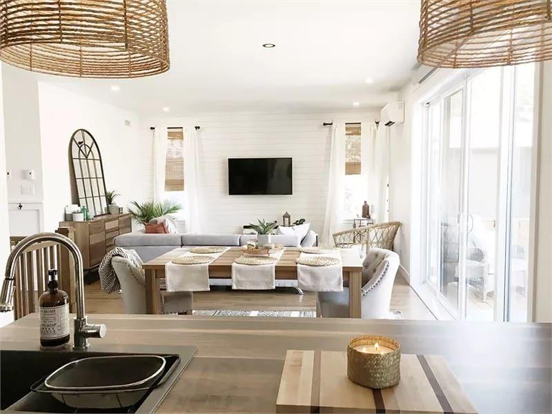 Open Living Area Featuring a Cozy Dining Setup and Lush Greenery