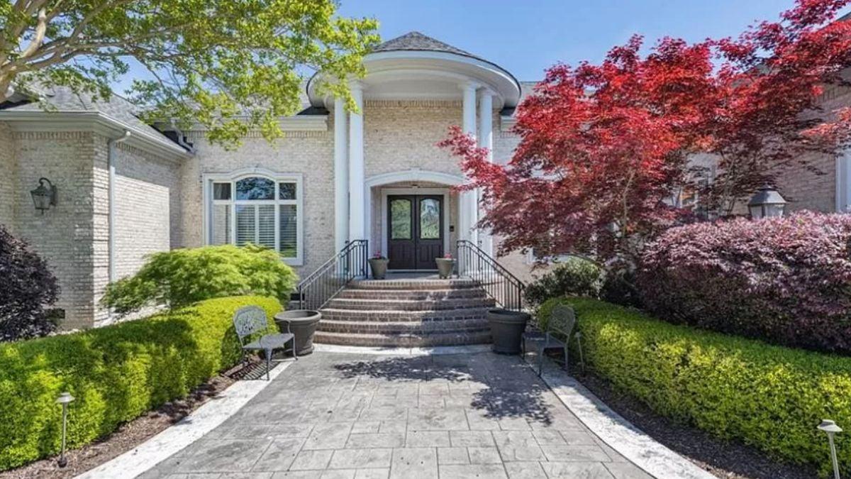 Grand Entrance Framed by Classic Columns and Vibrant Foliage