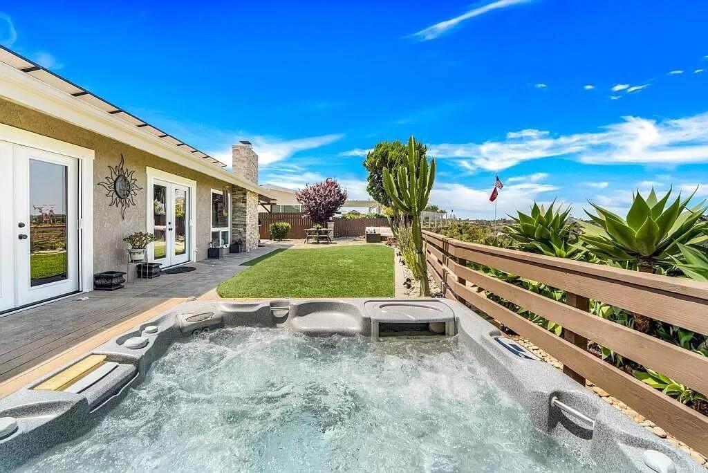 Relax in This Backyard Oasis with Its Inviting Hot Tub