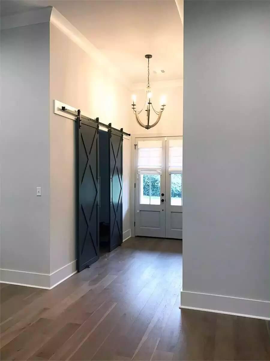 Modern Entryway with Sleek Barn Doors and Elegant Chandelier