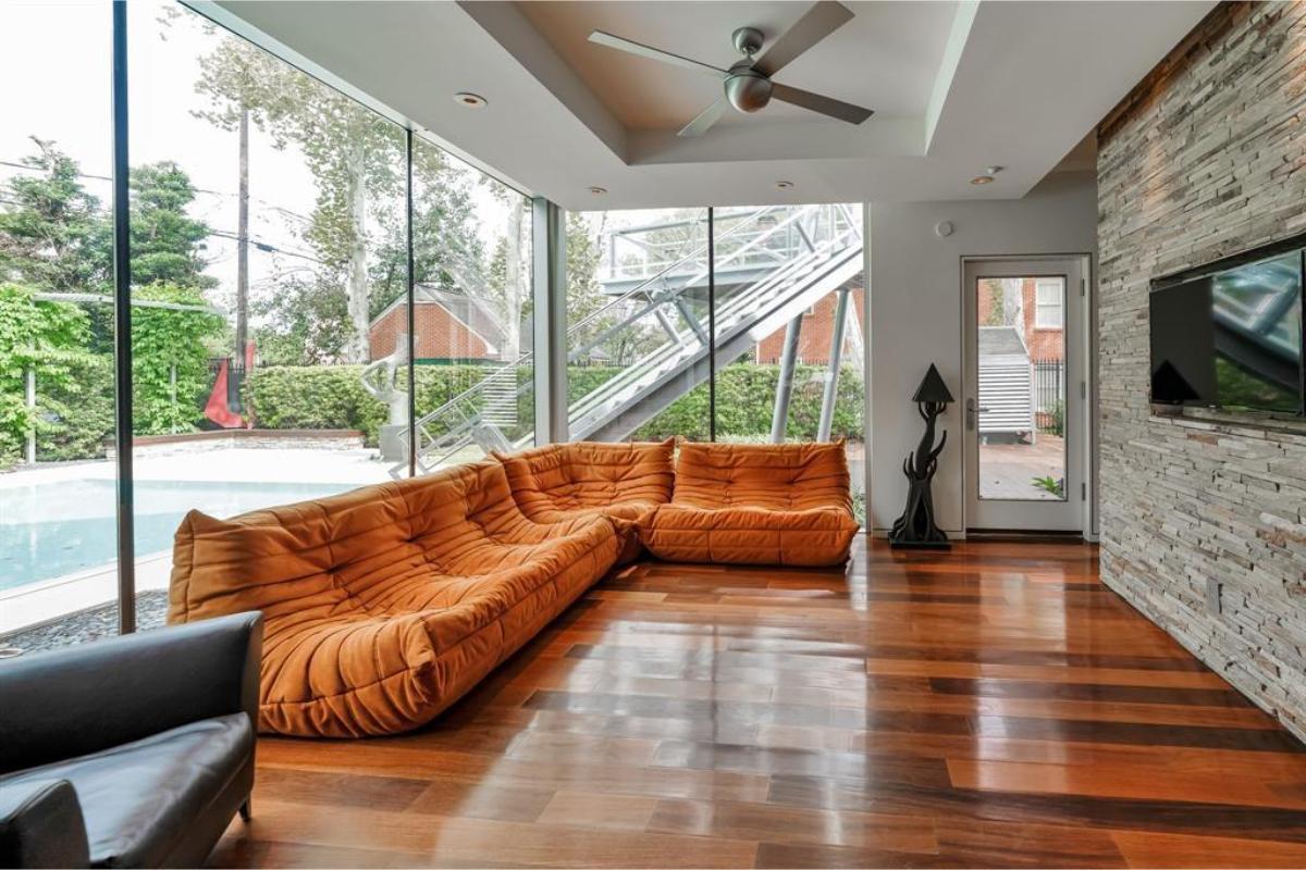 Check Out This Sunlit Living Room with Bold Orange Sectional