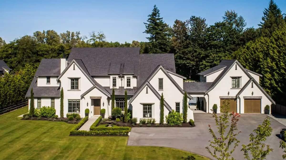 Admire the Crisp White Facade and Dramatic Rooflines in This Estate