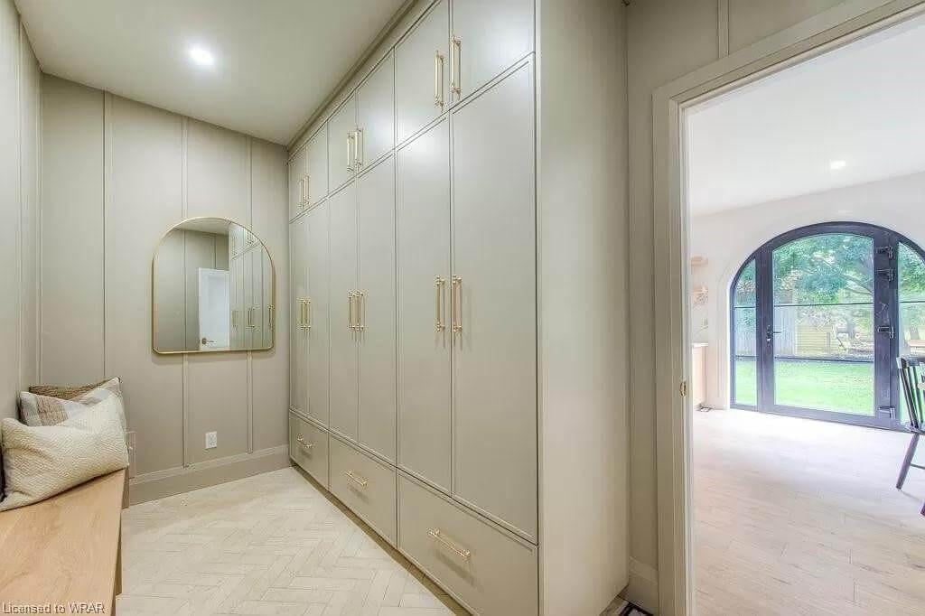 Sleek Mudroom with Built-in Storage and Elegant Arched Doorway