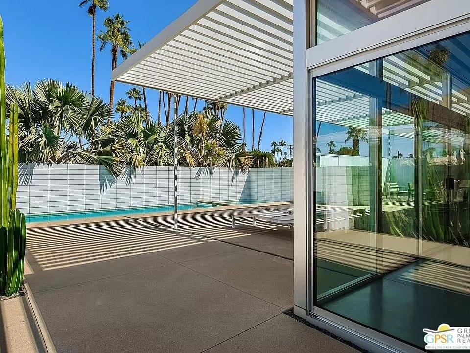 Sleek Outdoor Lounge with Modern Pergola and Poolside Views