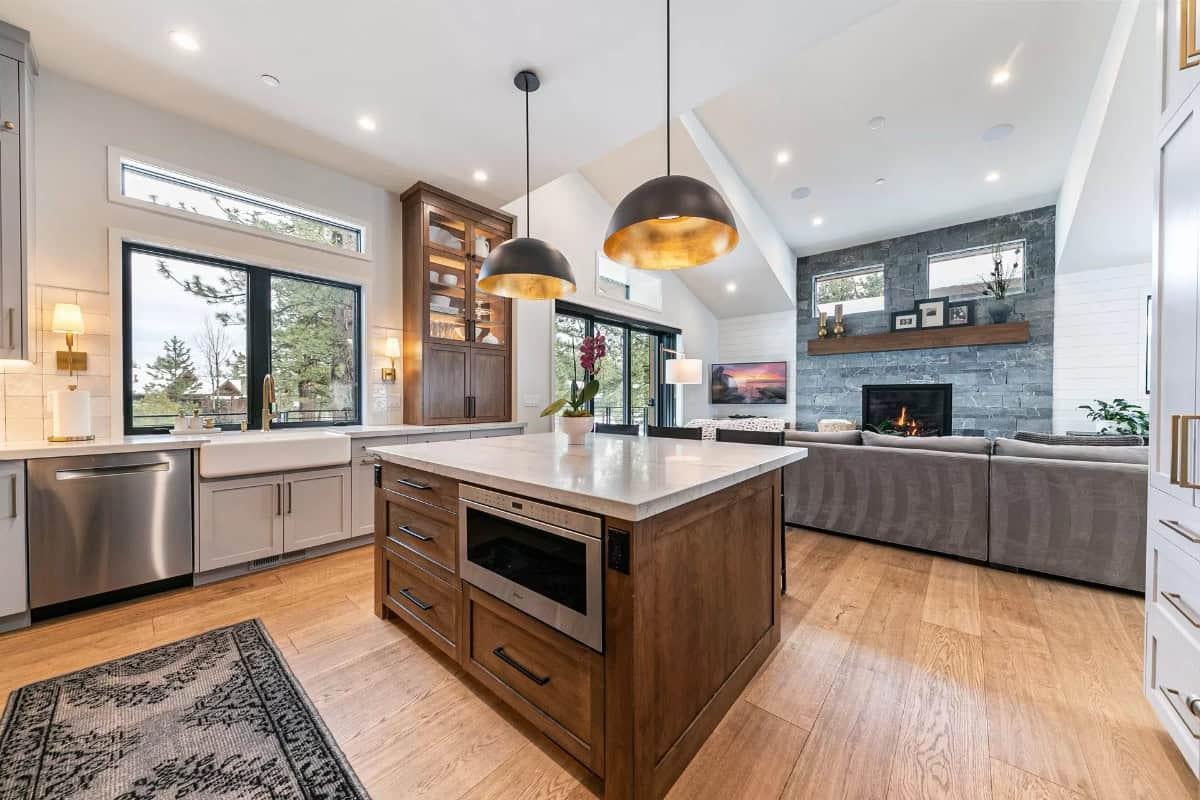 Check Out Those Striking Gold-Lined Pendants Above the Spacious Kitchen Island