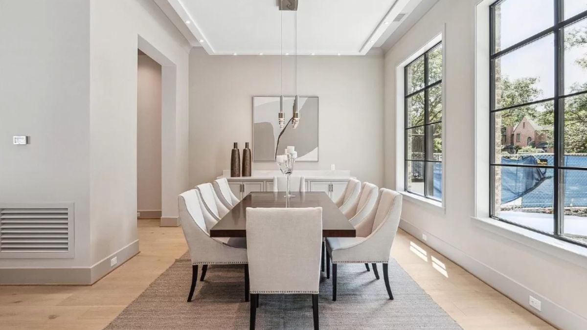 Elegant Dining Room with Statement Lighting and Expansive Windows