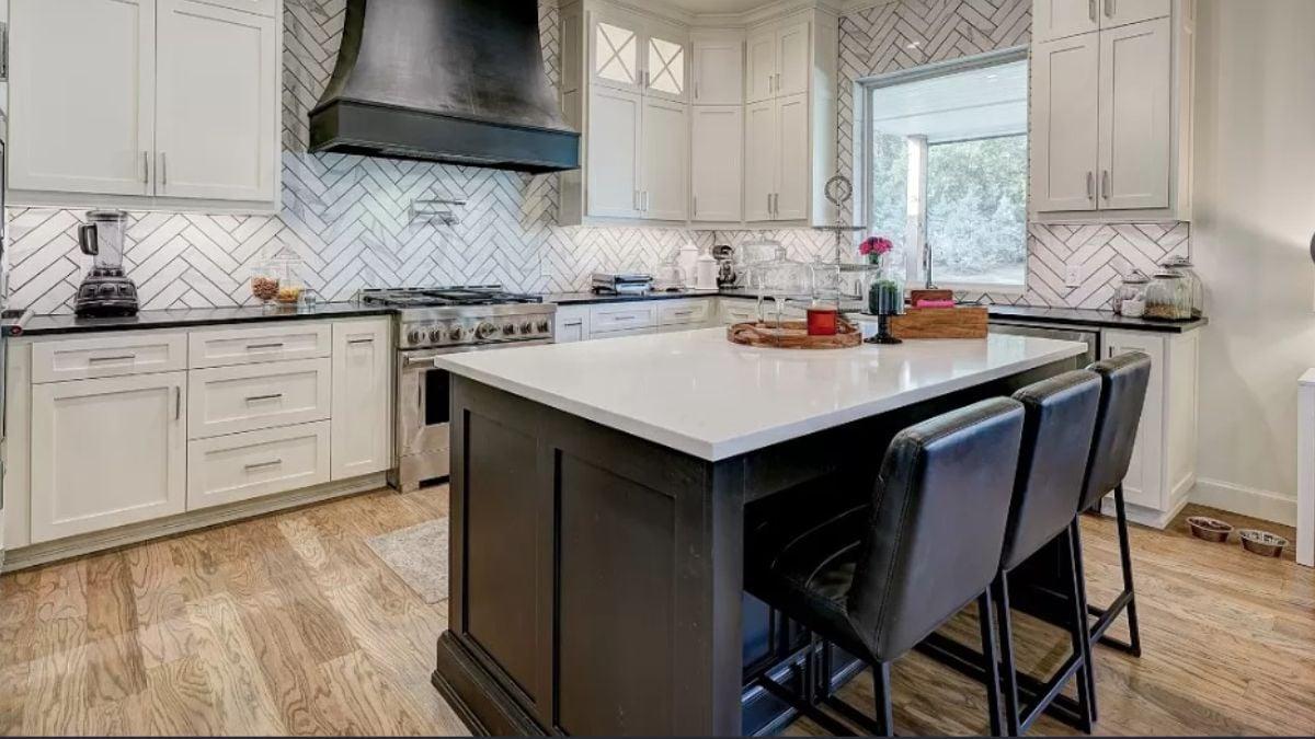 Notice the Bold Range Hood Complementing This Sleek Kitchen