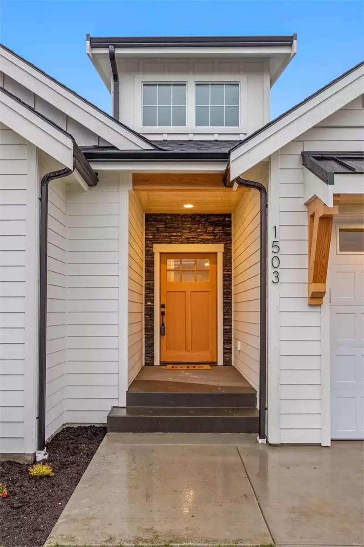 A Warm Welcome: Craftsman Entryway with a Striking Wooden Door