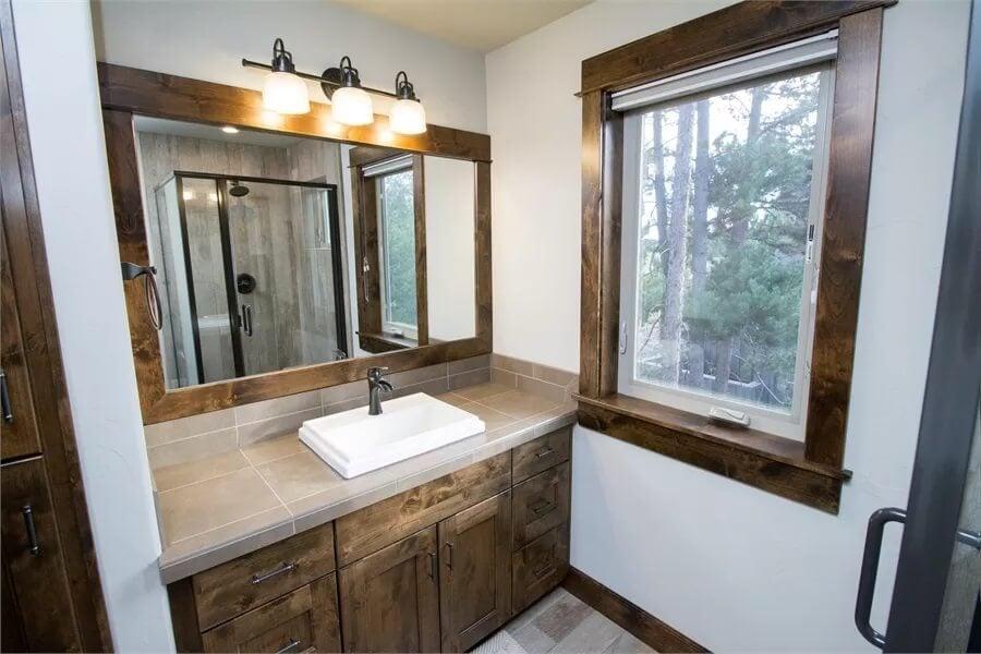 Rich Wood-framed Mirror Takes Center Stage in This Bathroom