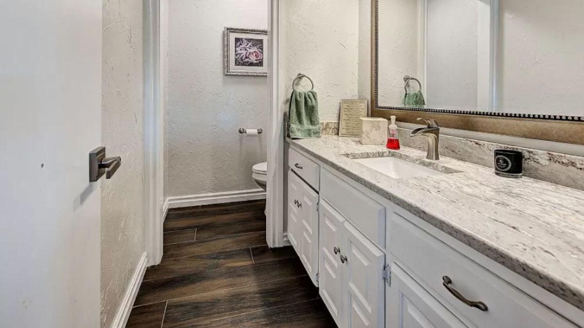 Sleek Bathroom Vanity with Granite Countertop and Beveled Mirror
