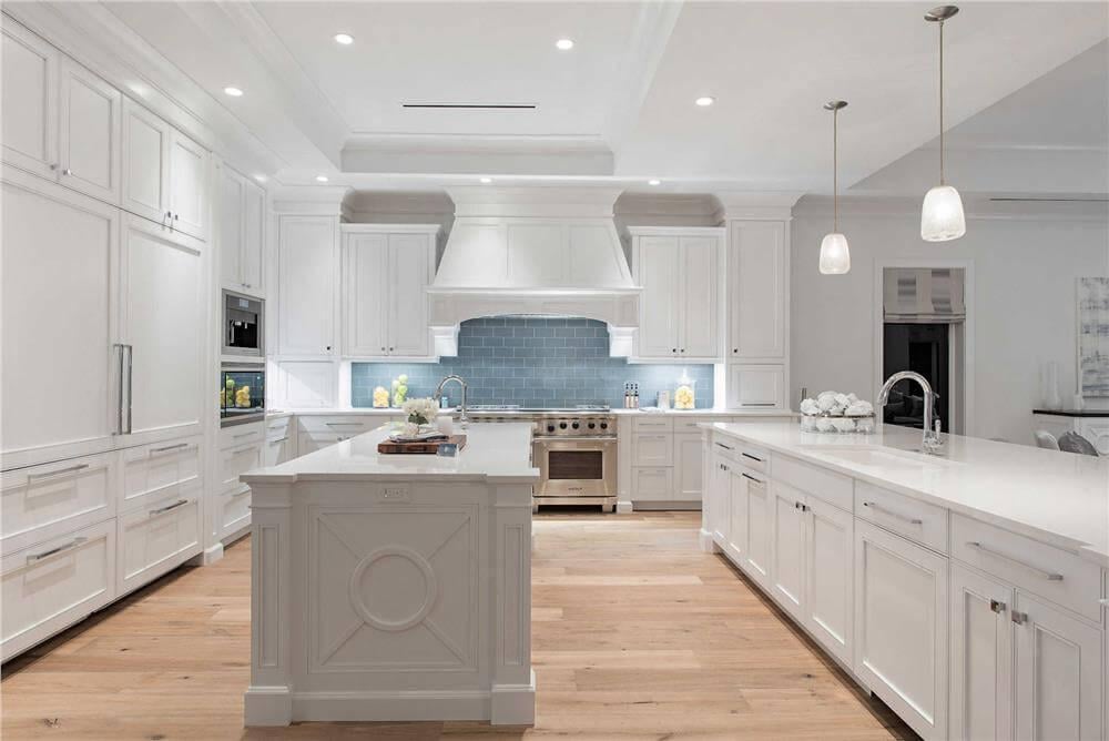Expansive Kitchen with Dual Islands and Elegant Pendant Lights