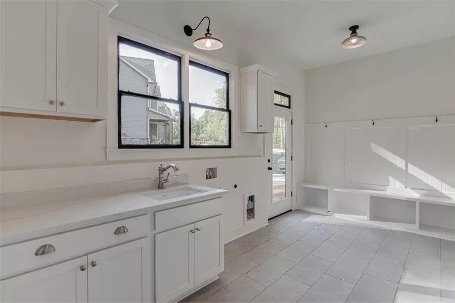 Spacious Laundry Room with Handy Built-In Bench and Hooks