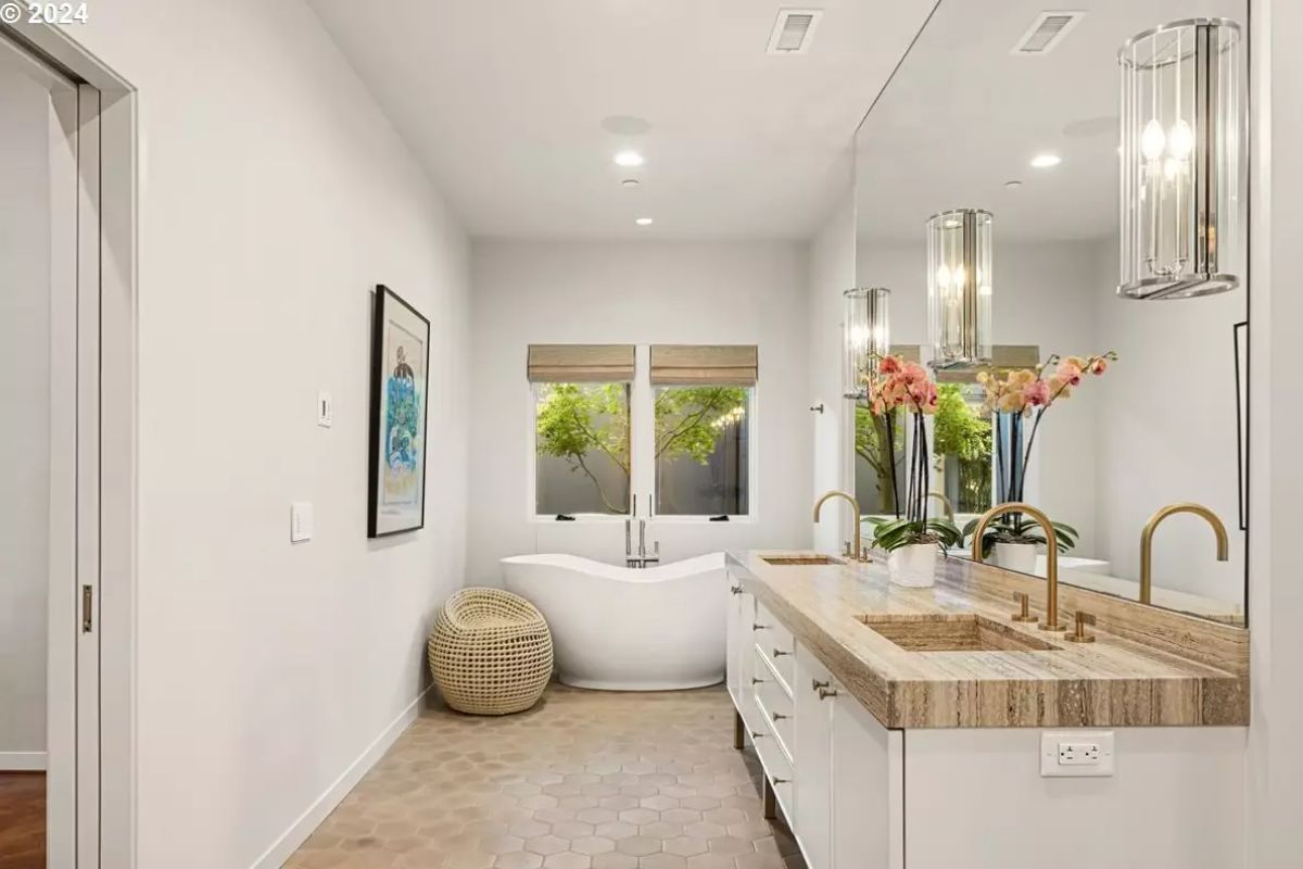 Bathroom with sculptural tub and woven accent basket. 