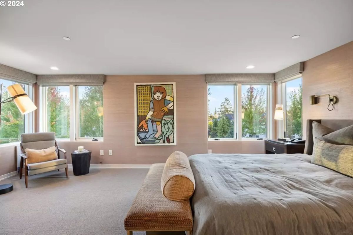 Secondary bedroom with contemporary artwork and corner windows. 