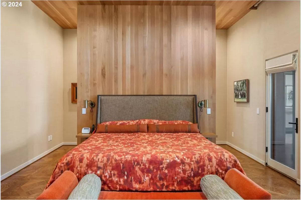 Bedroom with vertical wood wall and matching bench. 