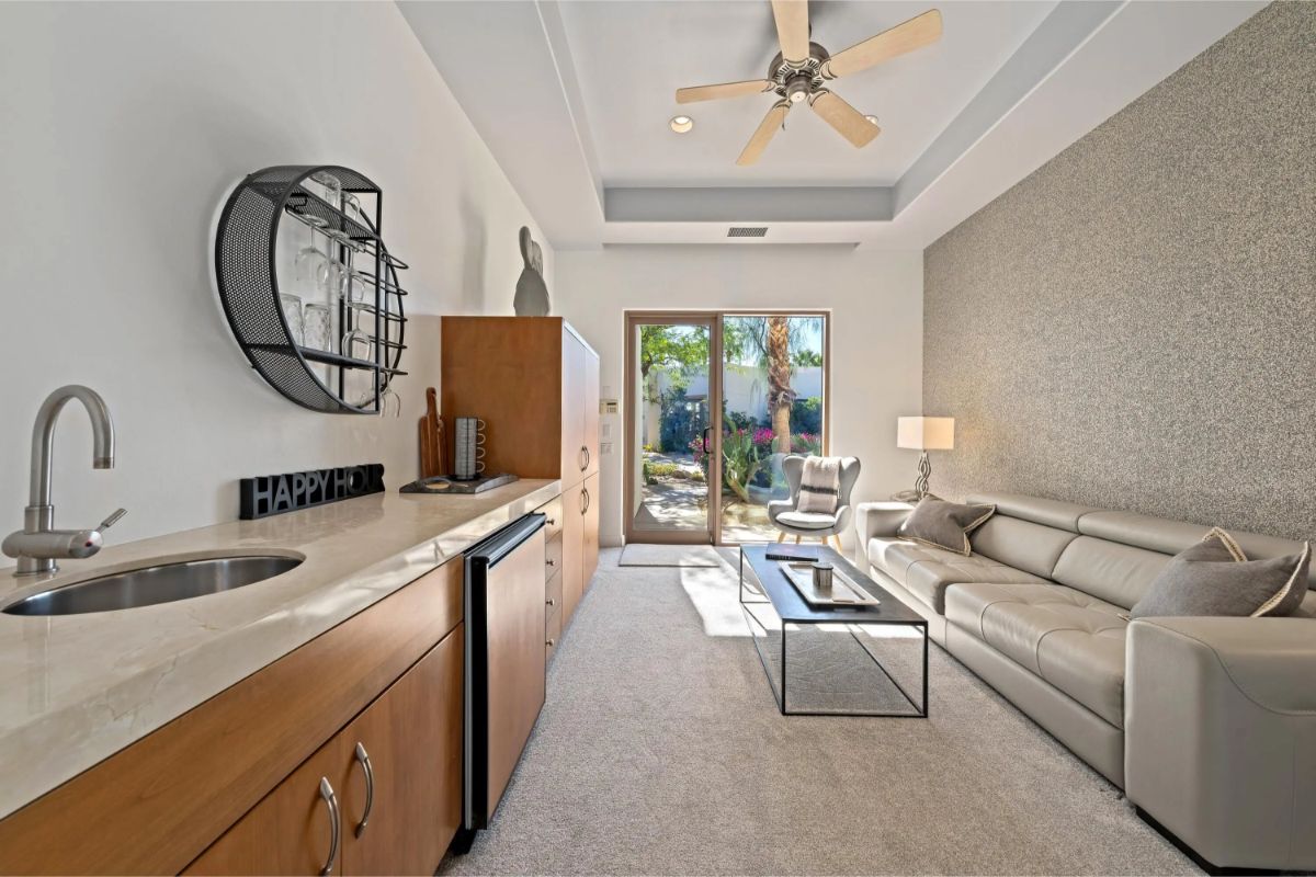 Compact lounge with built-in wet bar and access to a private patio. 