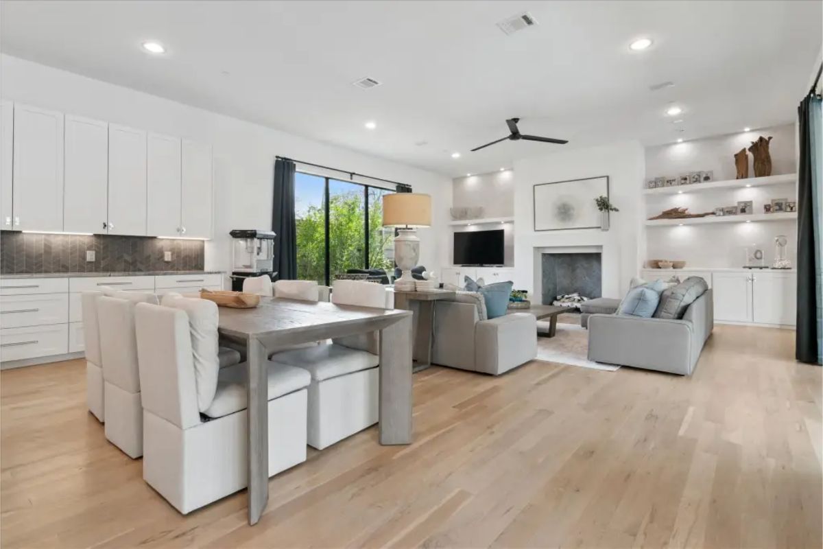 Alternate angle of living area showing dining space and fireplace with built-ins. 