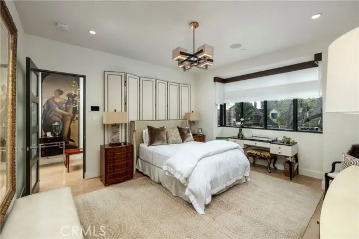 Secondary bedroom with corner windows, neutral palette, and integrated storage. 