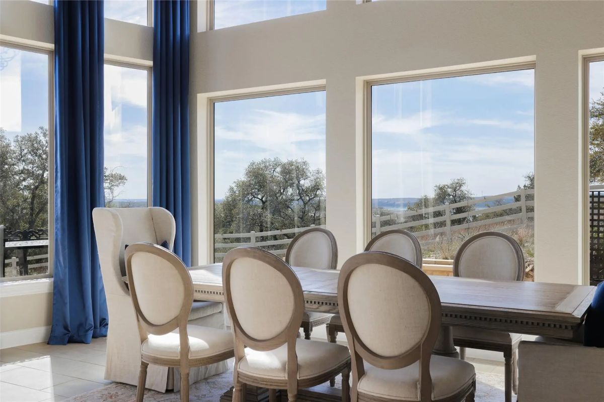 Rectangular dining table surrounded by upholstered chairs.