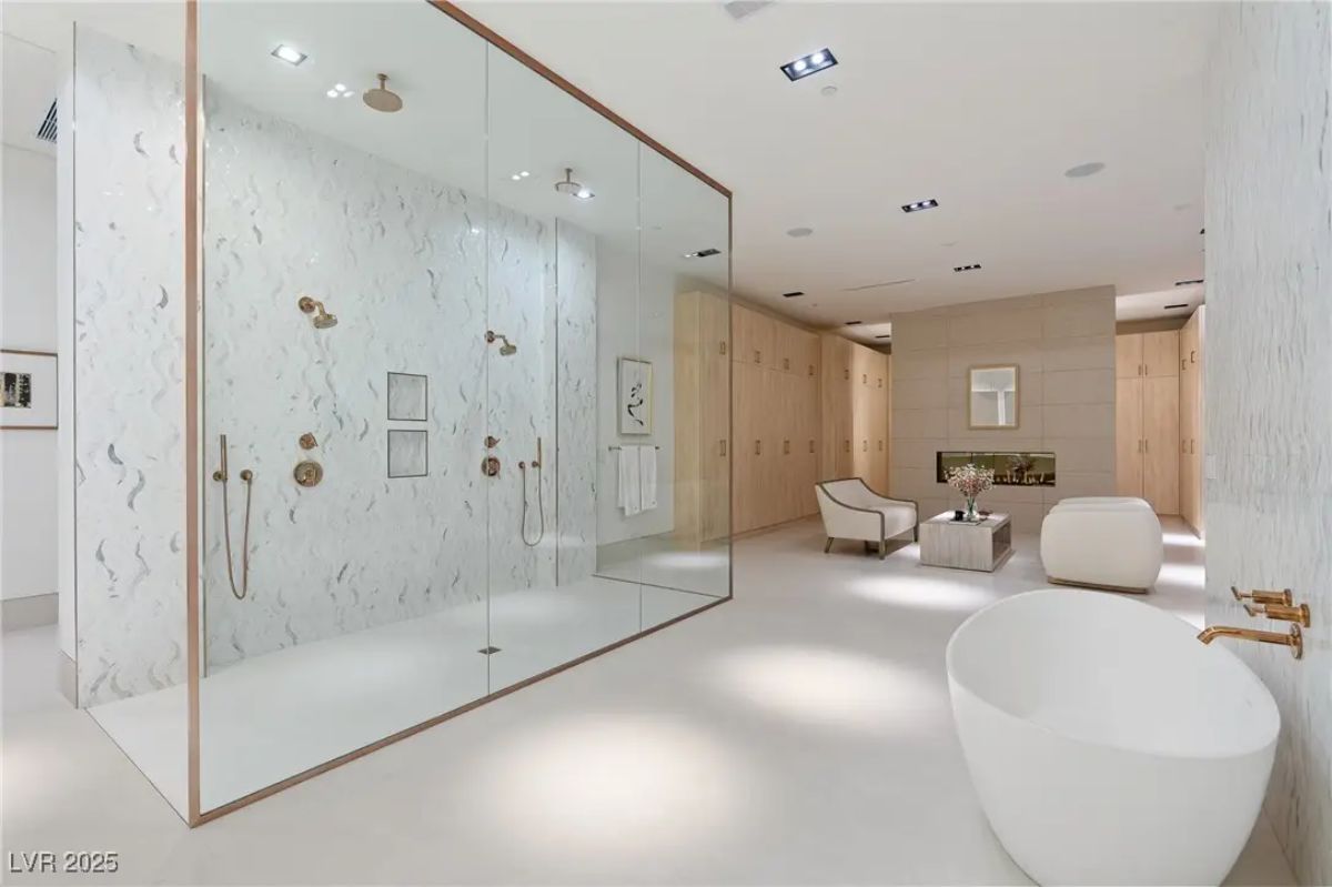Expanded bathroom view showing dual shower, seating area, and integrated closet space. 