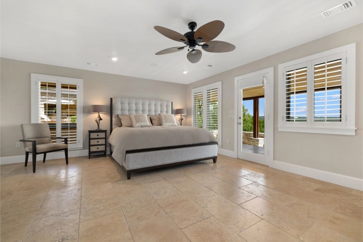 Alternate view of the same bedroom showing additional windows and side door. 