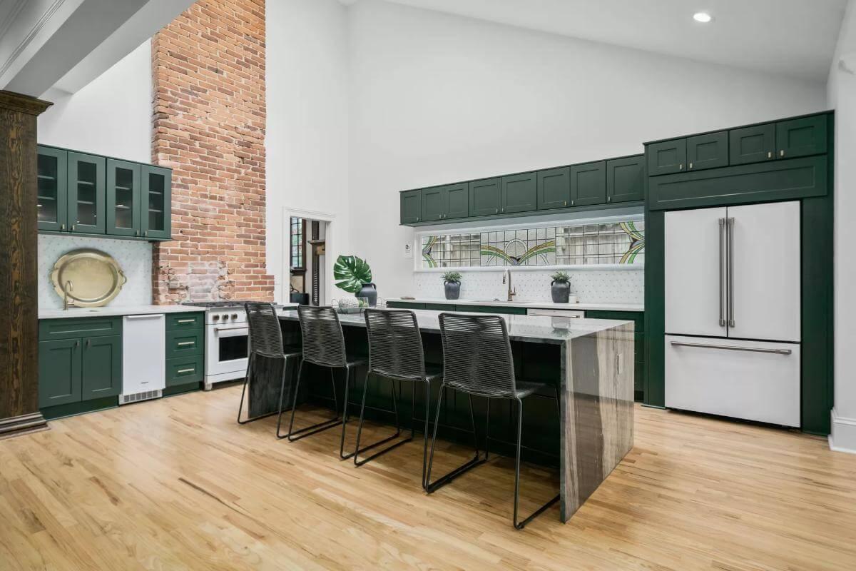 Wow, Check Out the Striking Green Cabinets and Bold Brick Feature Wall