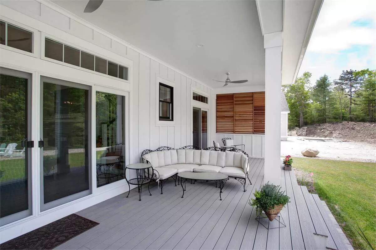 Charming Back Porch with Intricate Wrought-Iron Seating