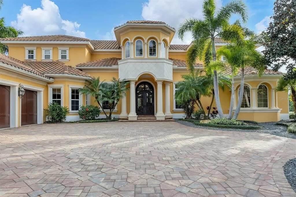 Grand Mediterranean Entrance with Majestic Turret and Lush Palm Framing