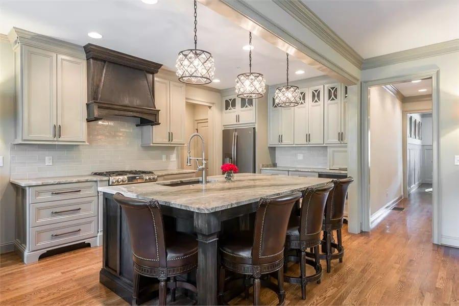 Kitchen Island with Intricate Pendant Lighting and Leather Seating