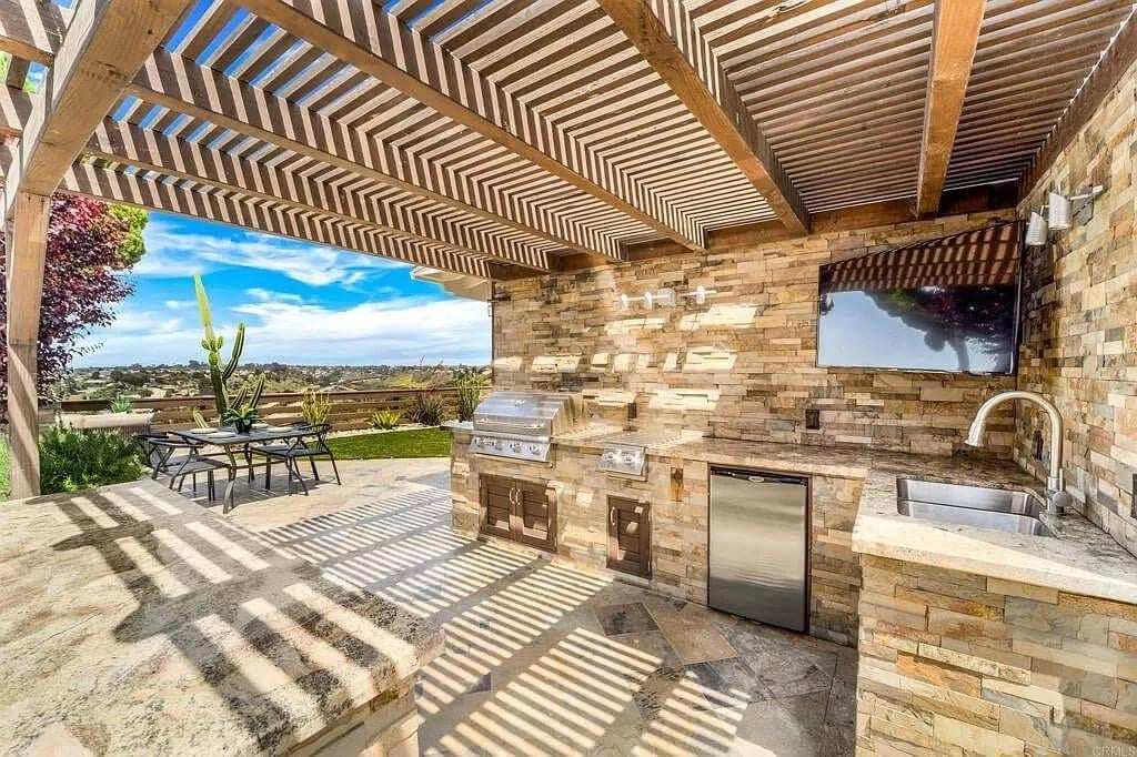 Explore This Outdoor Kitchen with a Striking Stone Facade