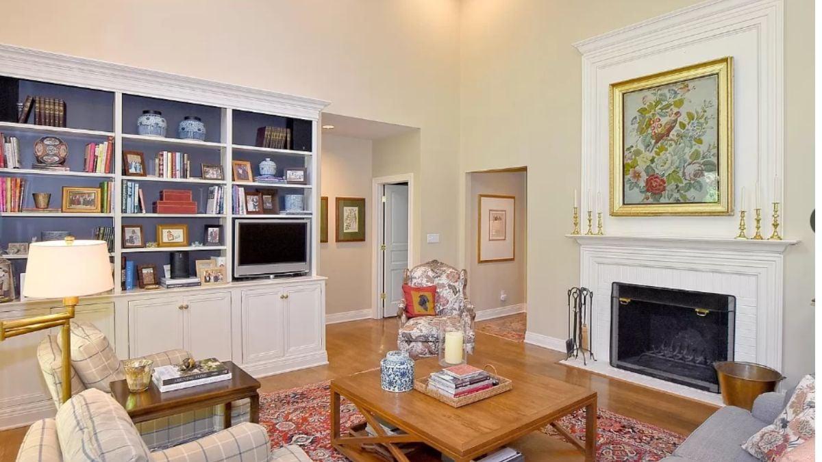 Elegantly Adorned Living Room with Built-In Bookcase and Floral Art