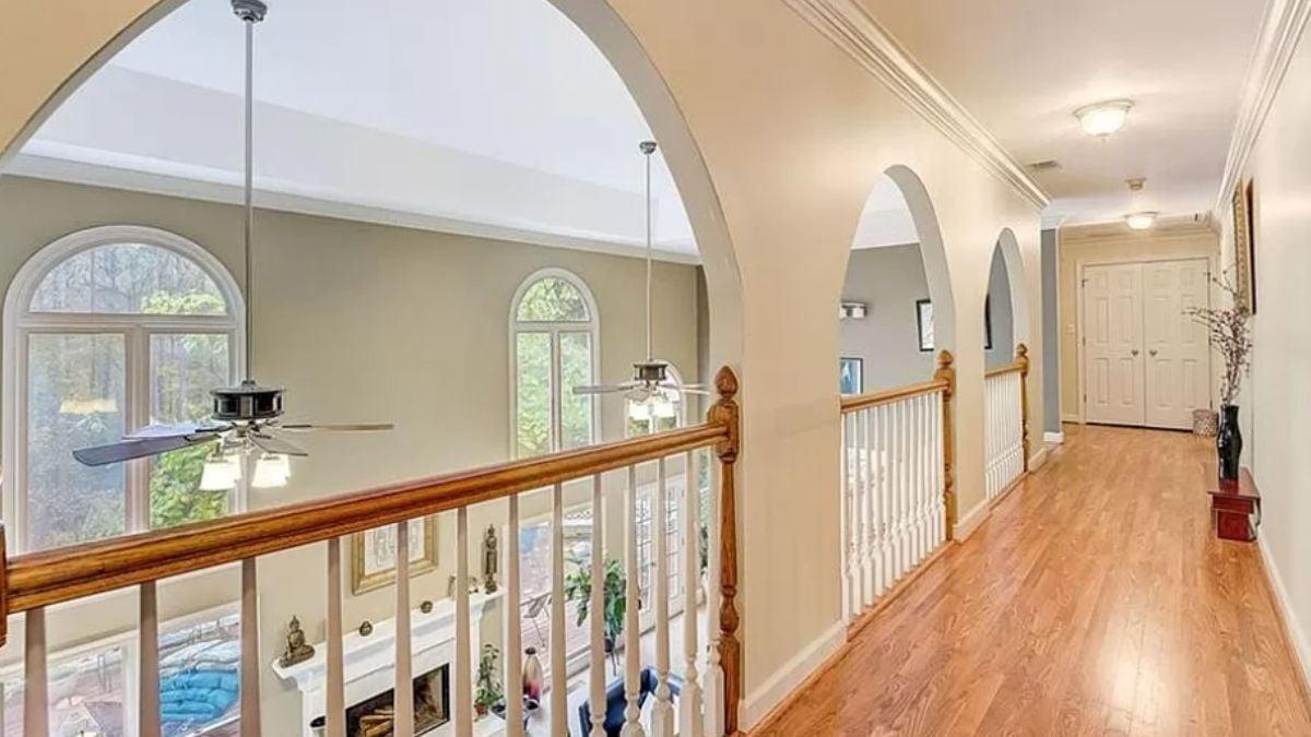 Elegant Hallway with Arched Openings and a View Below