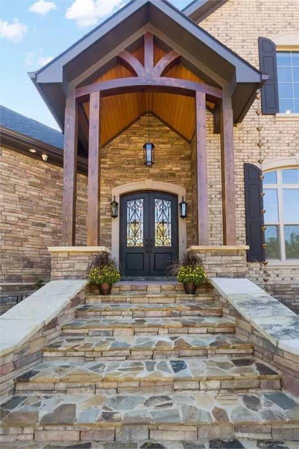 Stately Stone Entryway with Timber Accents and Grand Double Doors