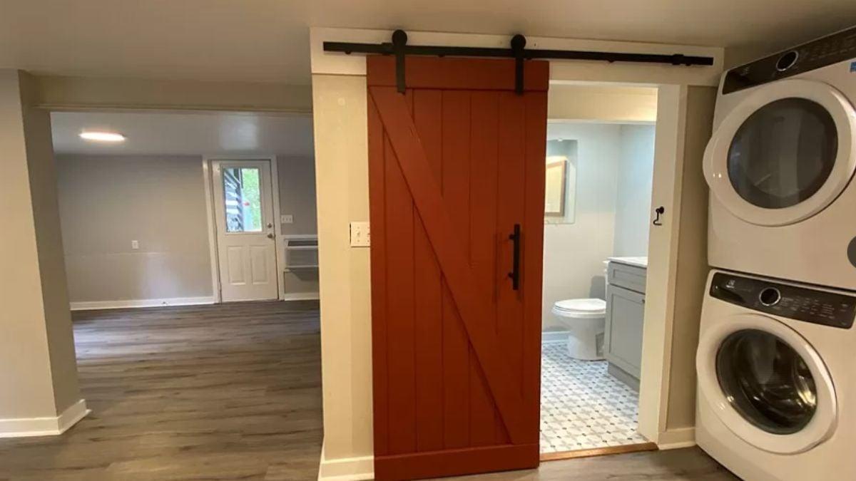 Check Out the Bold Red Barn Door in This Compact Laundry Closet