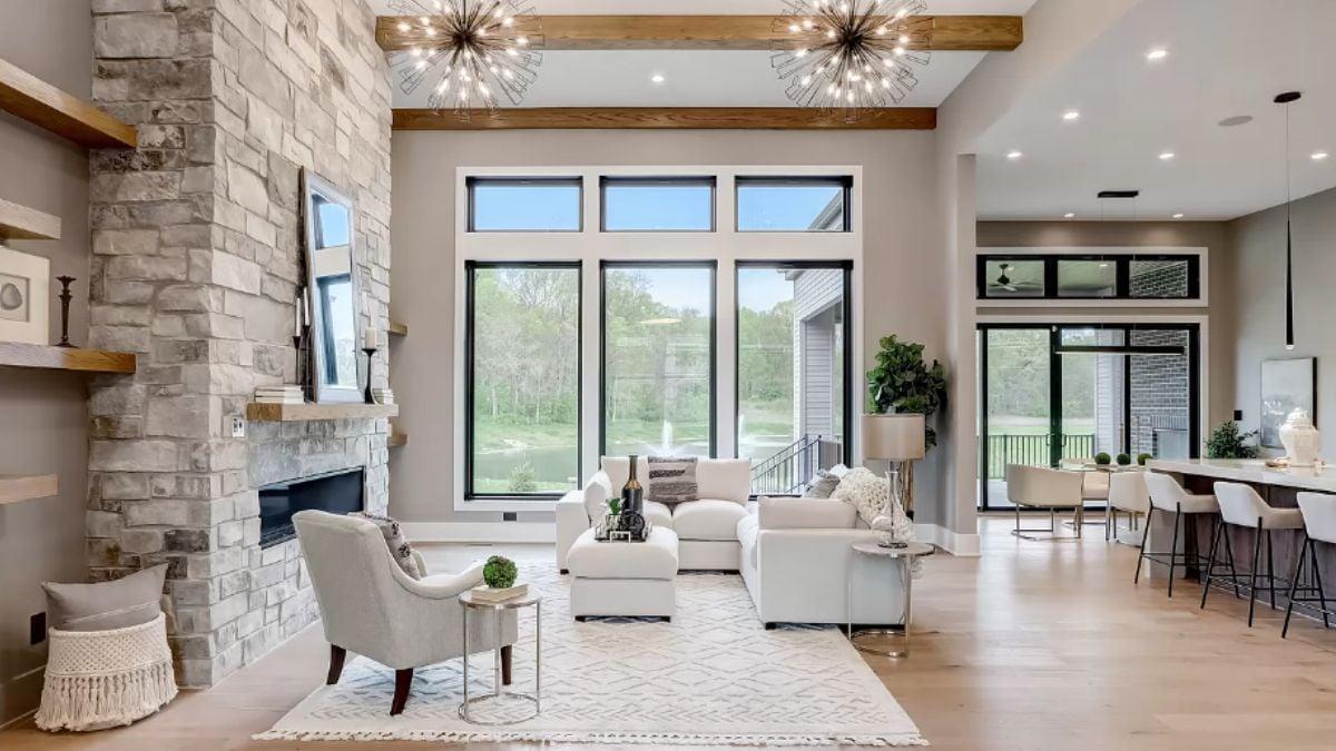 Lounge in Style with a Stunning Stone Fireplace and Modern Chandeliers