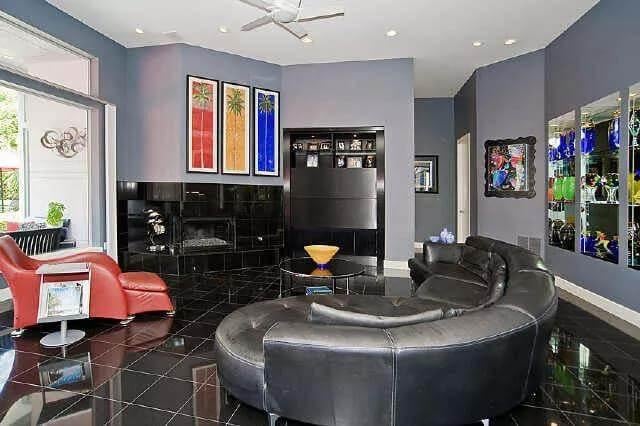Sleek Black Tile Flooring Anchors This Vibrant Living Space
