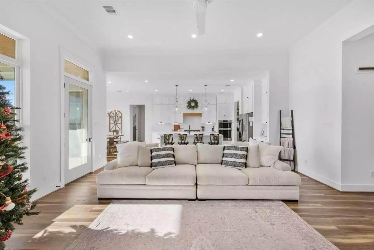 Open-Concept Living Room with Plush Sofa and a Glimpse of Modern Kitchen