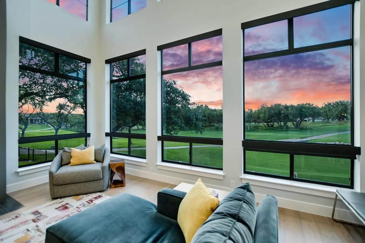 Modern Living Area with Expansive Windows and Gorgeous Sunset Views