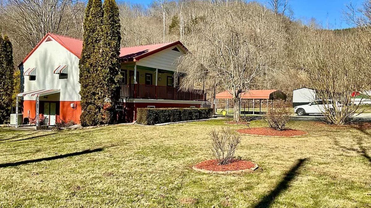 Check Out the Striking Red Roof on This Inviting Country Retreat