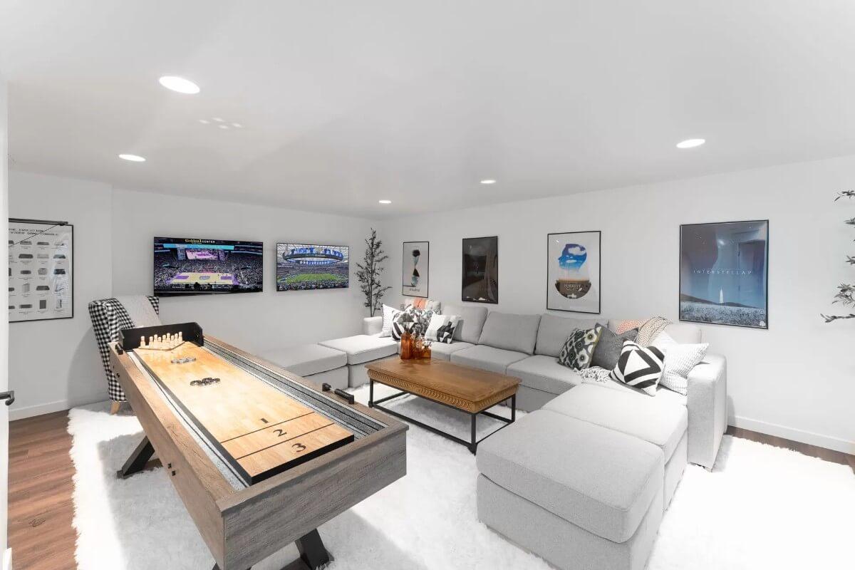 Game Room Delight with a Shuffleboard Table Front and Center